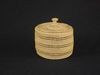 An Attu open work basket with a cover