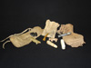 Three Navajo fetishes with hide bags and prayer sticks