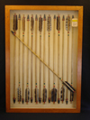 A frame of 15 fletched Hupa-Yurok wooden arrows